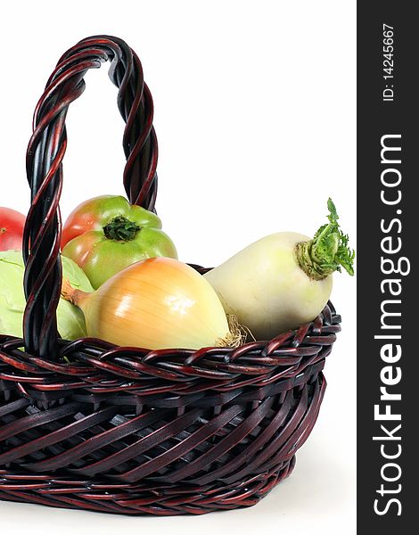 Basket with vegetables isolated on white background.