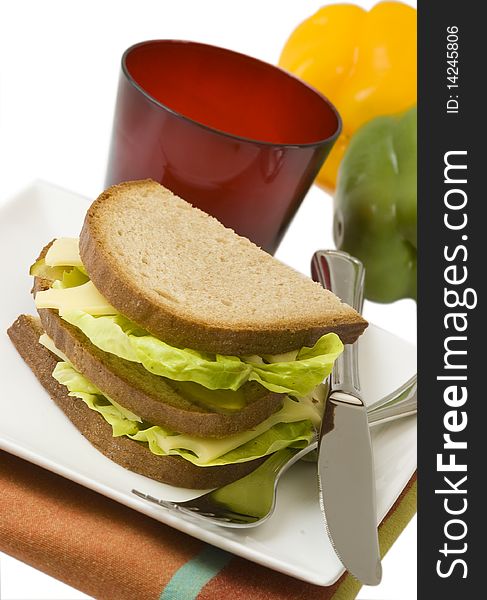 Dark bread sandwich with standing fork, isolated on white background