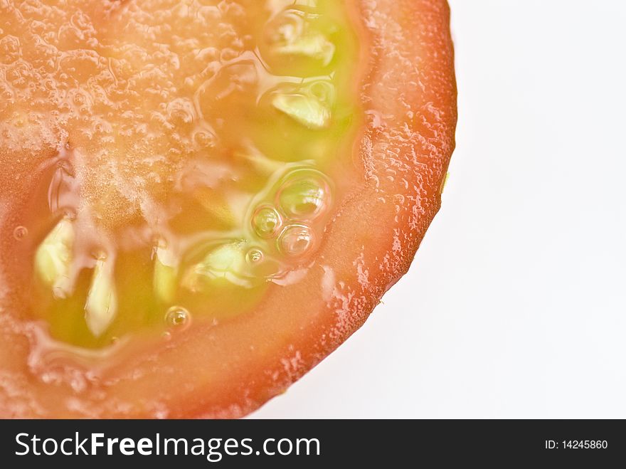 A macro shot of a sliced tomato. A macro shot of a sliced tomato
