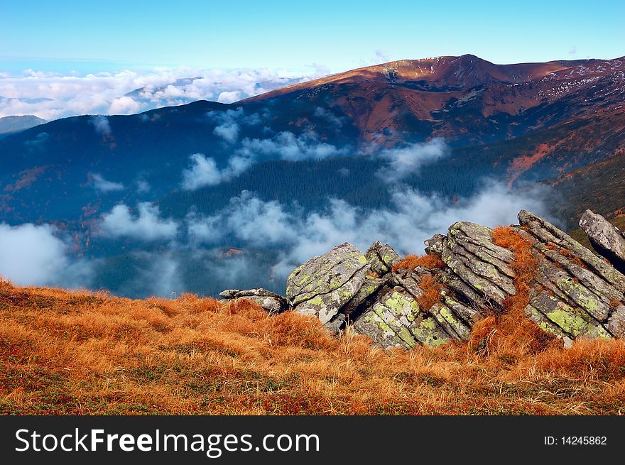 Mountain landscape with foggy clouds. Autumn morning. Mountain landscape with foggy clouds. Autumn morning