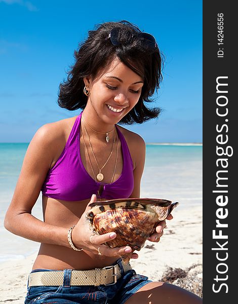 Caribbean woman holding a conch shell