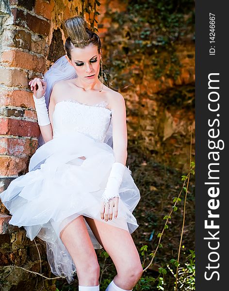 Bride standing by the stone wall. Bride standing by the stone wall