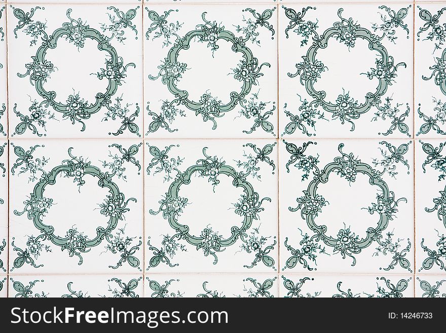 View of a beautiful green floral azulejo on a wall. View of a beautiful green floral azulejo on a wall.