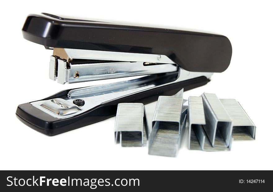 Black stapler and staples to him on white background