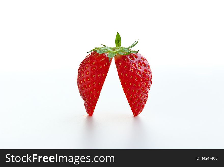 Fresh ripe strawberry cut into halves on white background. Clipping path included
