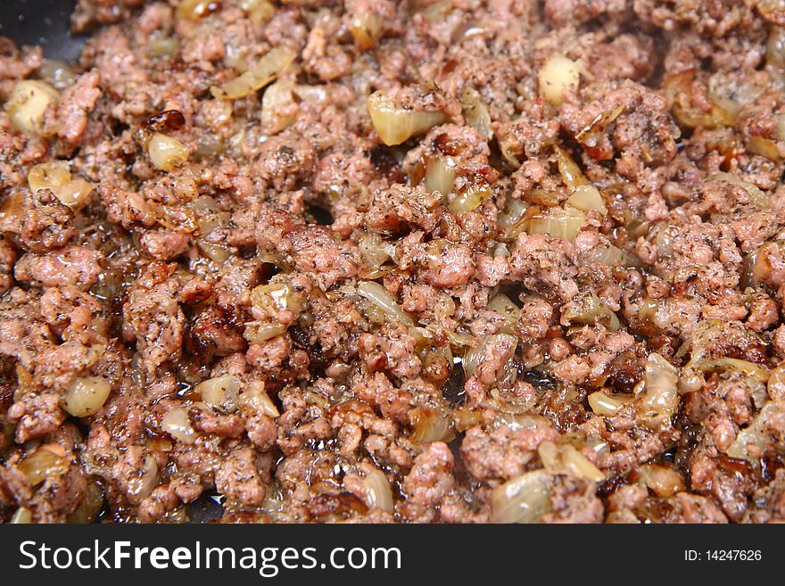 Minced meat and onion being fried on a pan