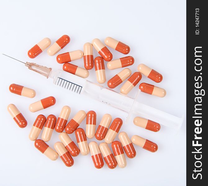 Syringe and pills