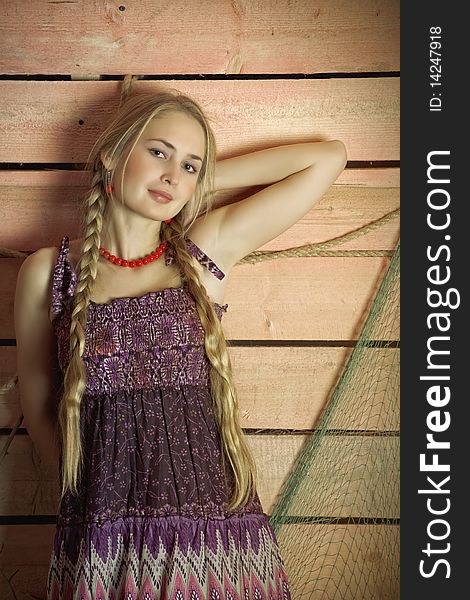 Portrait of a country girl with a wooden wall. Portrait of a country girl with a wooden wall.