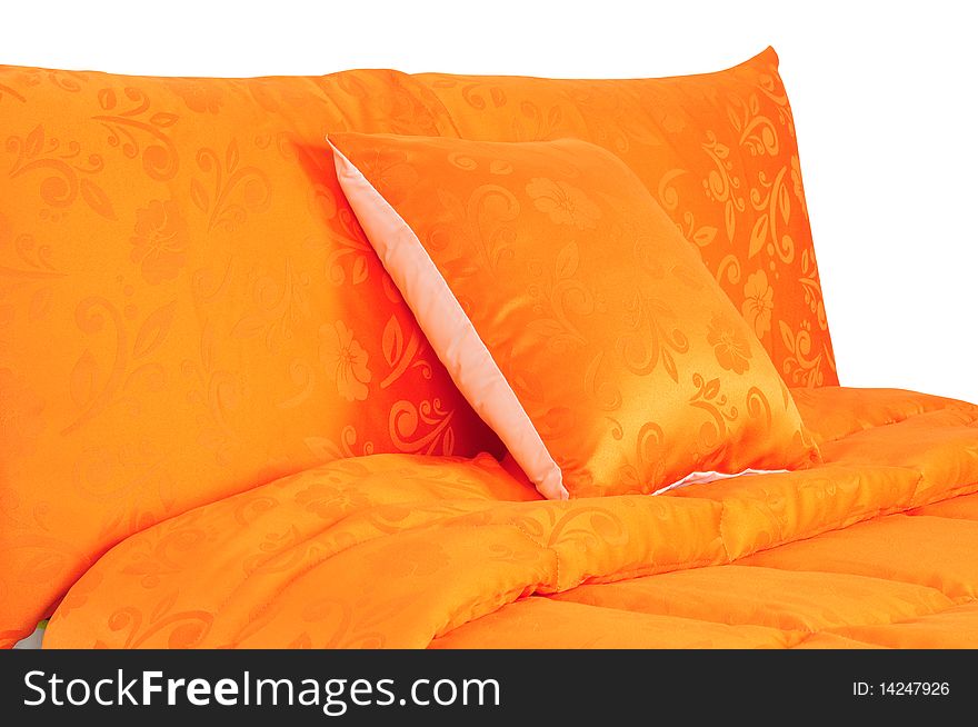 Vibrant orange bed spreads with extra pillow. Vibrant orange bed spreads with extra pillow.