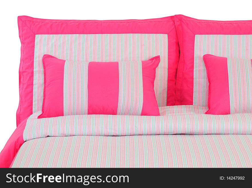 Pink stripped bed spreads over white. Pink stripped bed spreads over white.