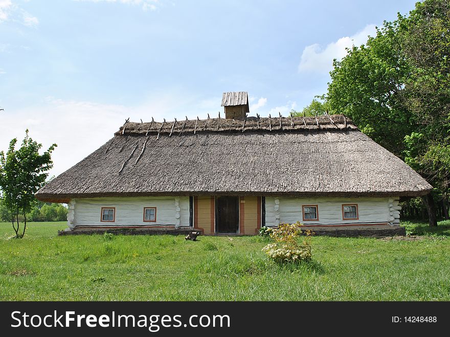 Old clay country house with straw roof