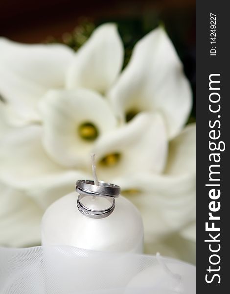 Wedding Rings and white Candle and Flowers. Wedding Rings and white Candle and Flowers
