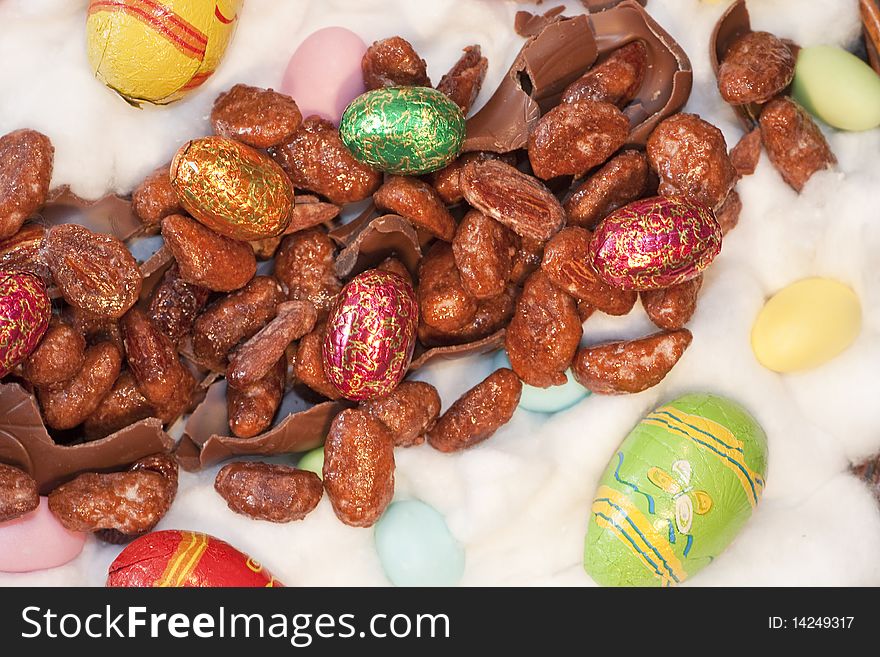 View of several colorful and painted easter eggs and sweet almonds. View of several colorful and painted easter eggs and sweet almonds