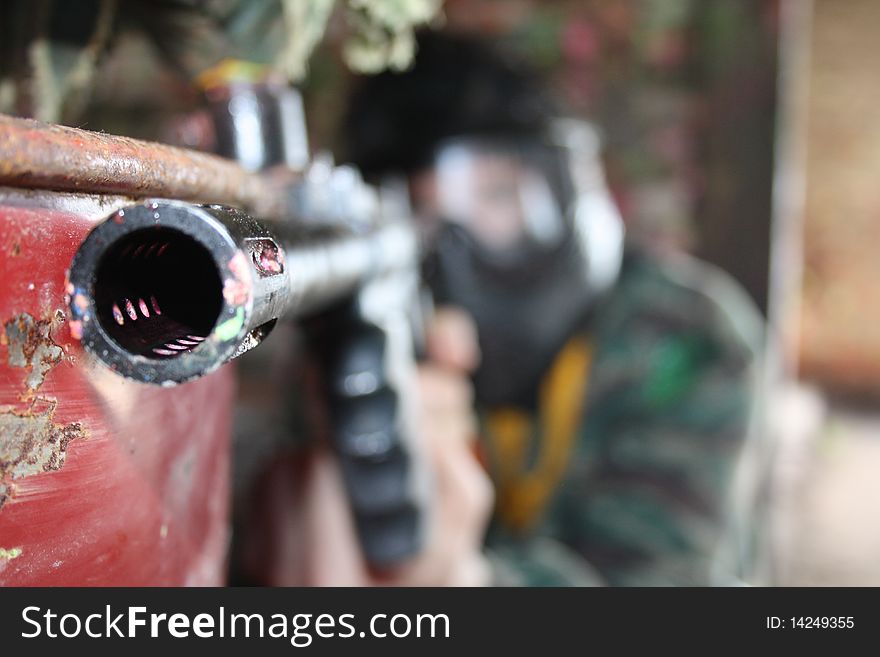 A paintball game war entertainment sports the person gun. A paintball game war entertainment sports the person gun