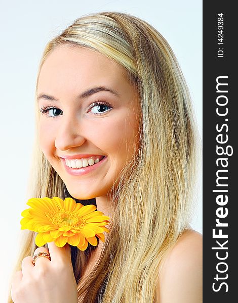 Young woman with a flower. Over white background