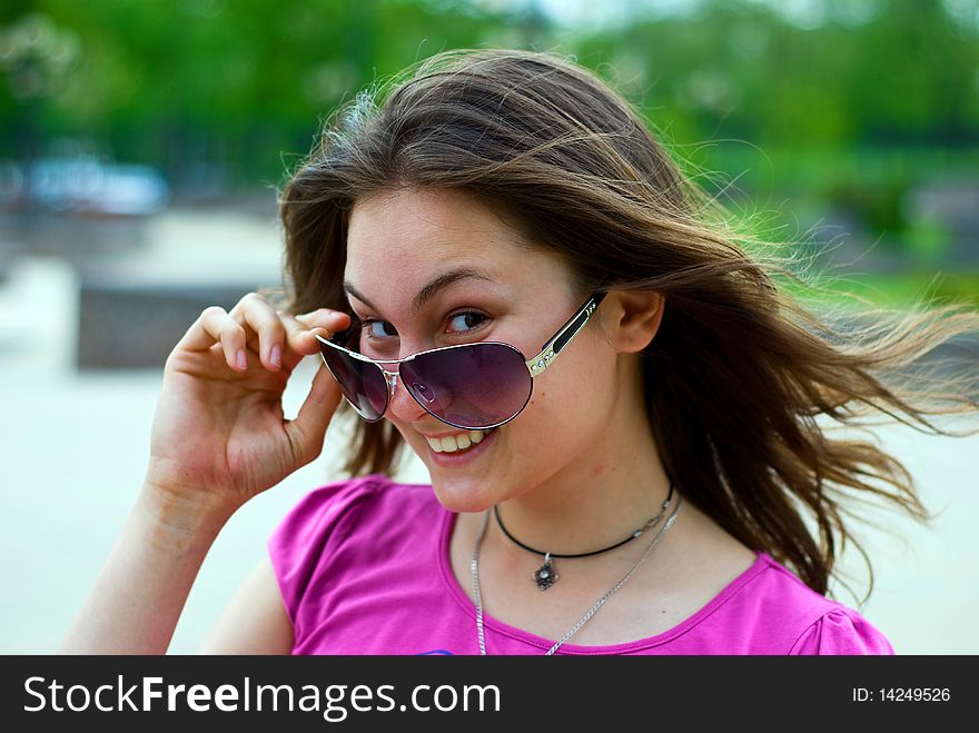 Portrait of a smiling beautiful teenage girl in sunglasses. Portrait of a smiling beautiful teenage girl in sunglasses