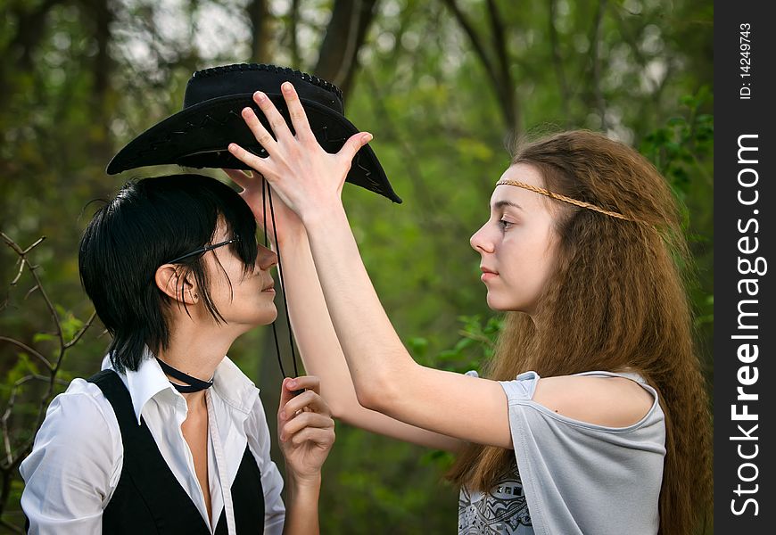 Two girls in the forest - American stylization like cowgirl and Indian