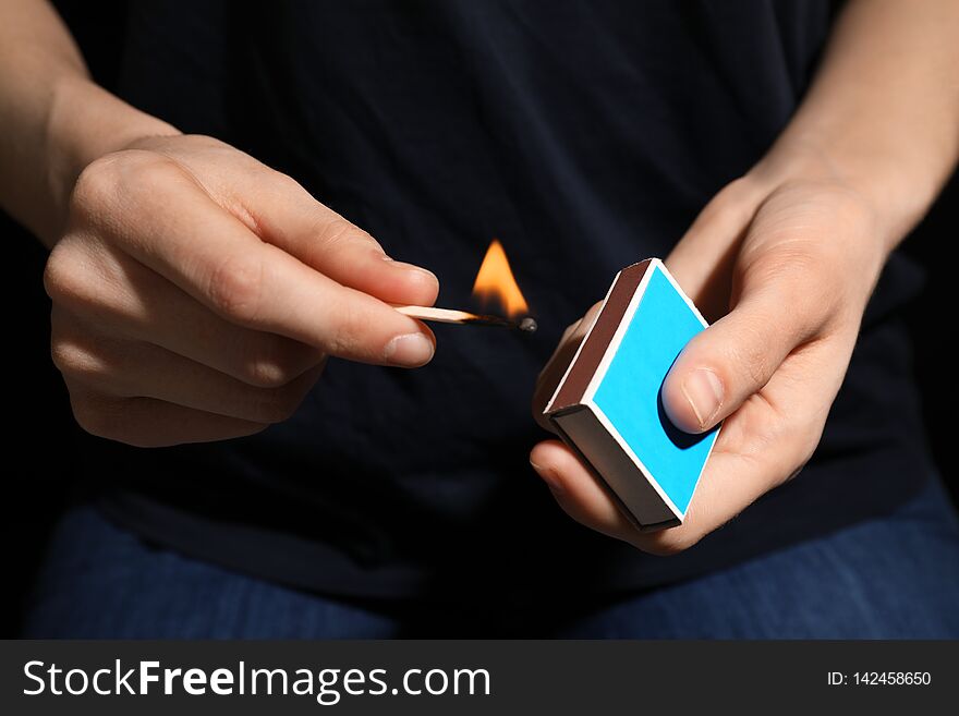 Woman with box of matches, closeup