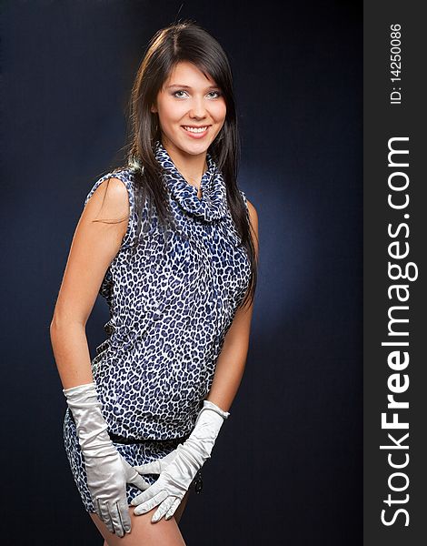Young beautiful woman in dress and gloves