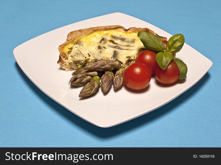 Asparagus omelet served with tomatoes and basil