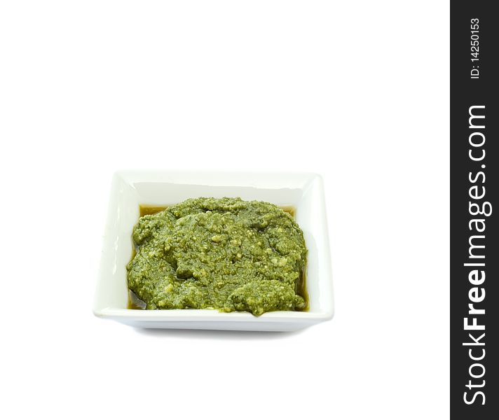 Cup basil sauce on a white background