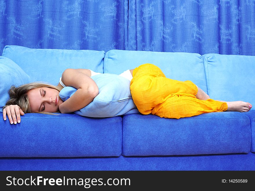 Young woman sleeping on blue sofa