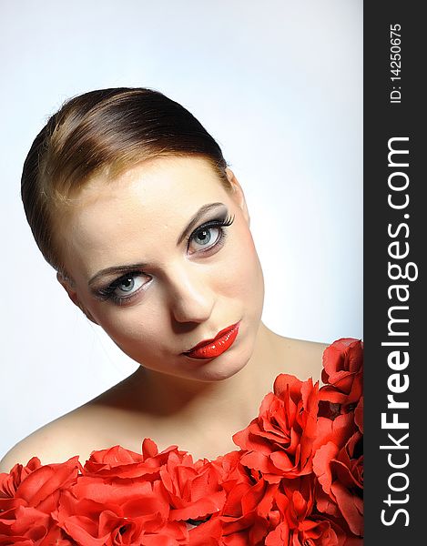 Young elegant aristocratic beauty female face with red shiny lips and black eye makeup. colse-up.