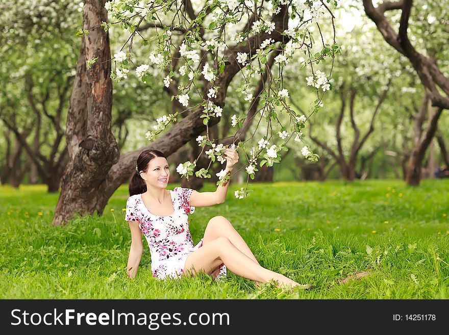 Beautiful smiling woman with flowering tree