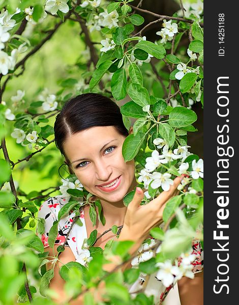 Beautiful smiling woman with flowering tree