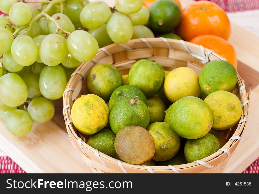 Limes in Basket with Tangerines and Grapes. Limes in Basket with Tangerines and Grapes