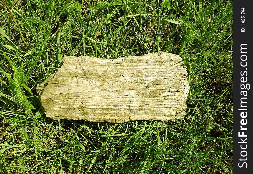 Wooden board on a grass background. Wooden board on a grass background