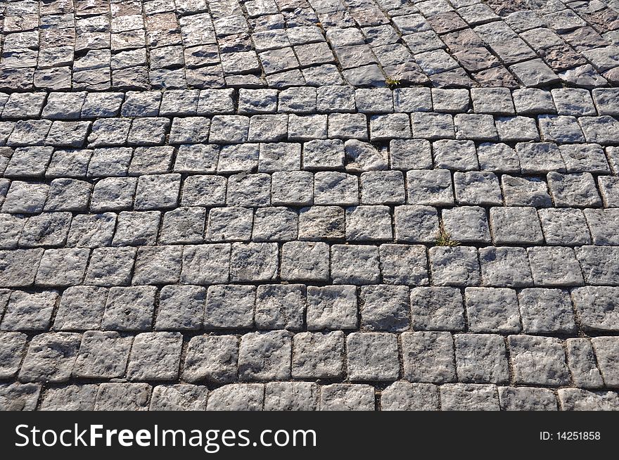 Texture of a common urban pavement - cobblestone. Texture of a common urban pavement - cobblestone