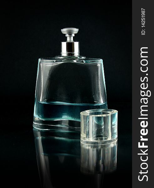 Perfume flask with cologne on black background