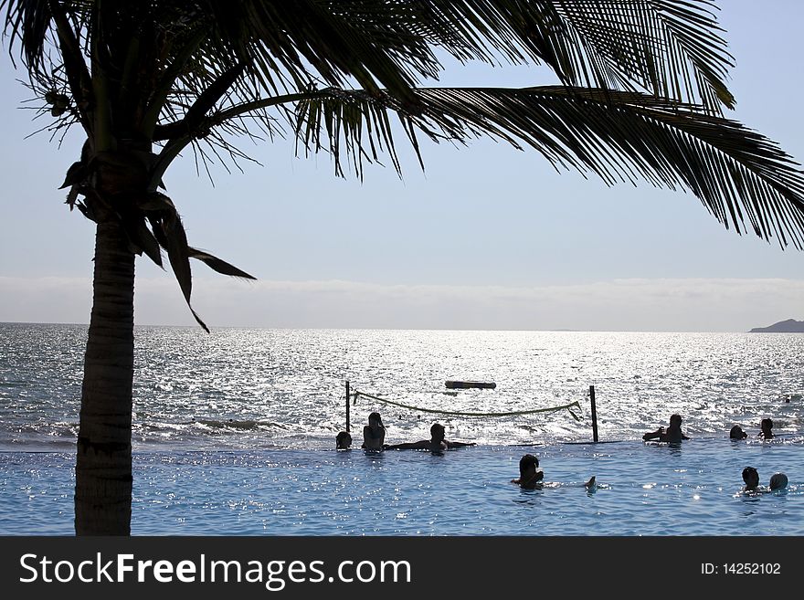 People in a perfect sunny day having fun at the pool. People in a perfect sunny day having fun at the pool