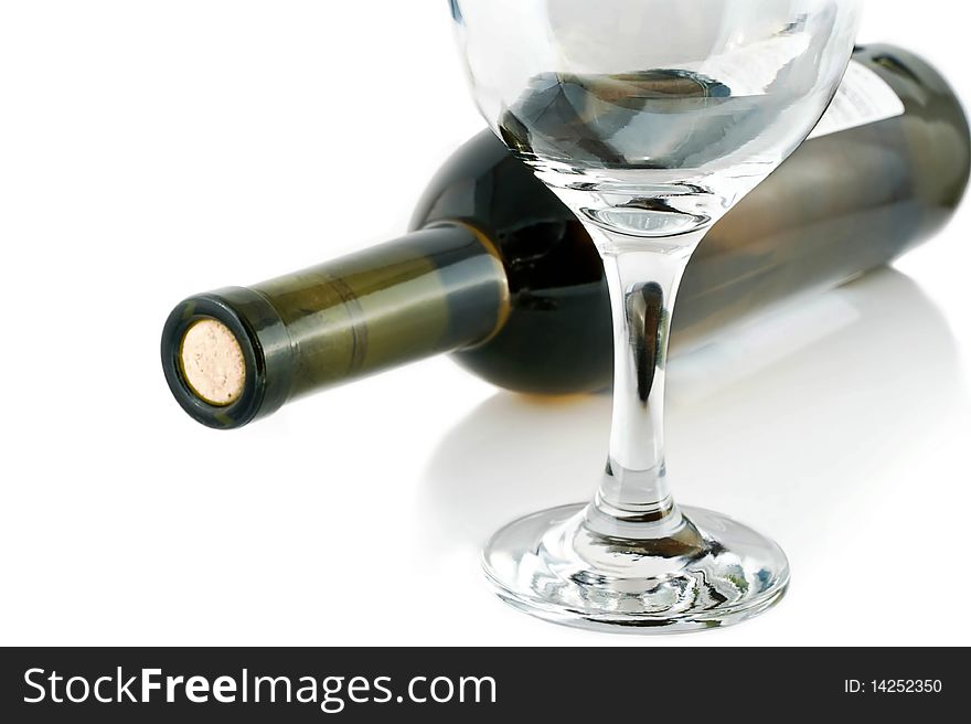 An empty glass on the background of bottles of red wine. An empty glass on the background of bottles of red wine