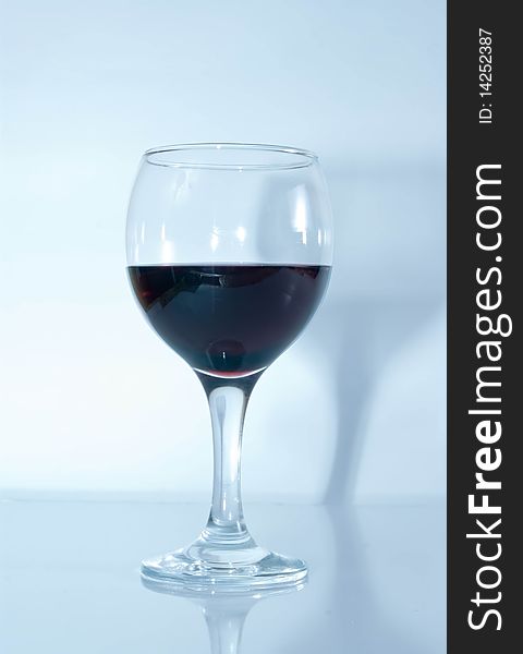 Red wine glass in blue