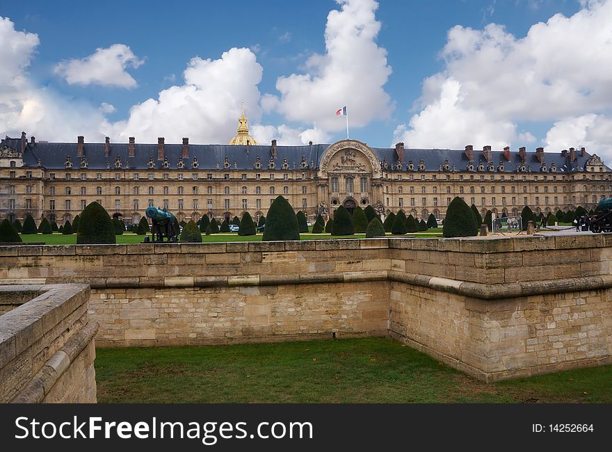 This is the war museum in Paris , it has a park in front  with small  trees and defiance canal. This is the war museum in Paris , it has a park in front  with small  trees and defiance canal