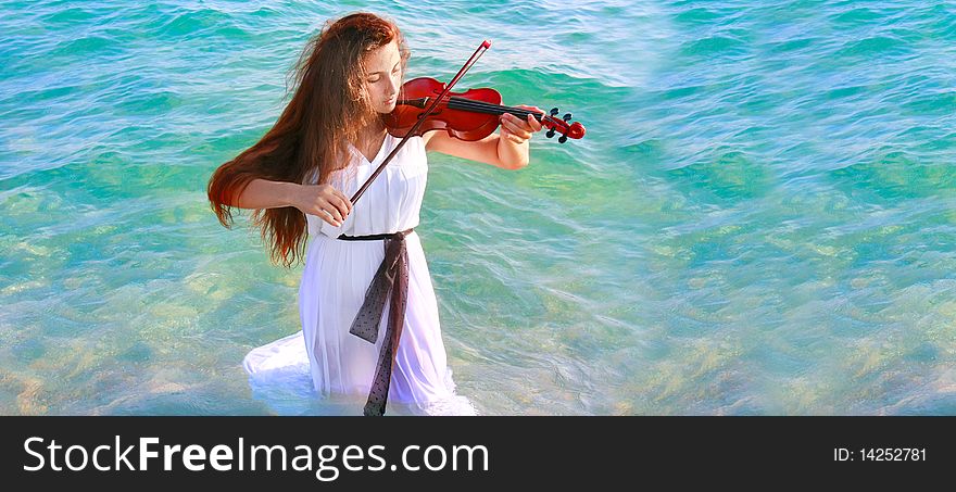 Young beautiful woman playing violin in water. Young beautiful woman playing violin in water