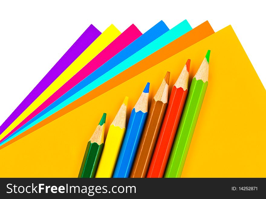 Multicolored paper and pencils isolated on white background