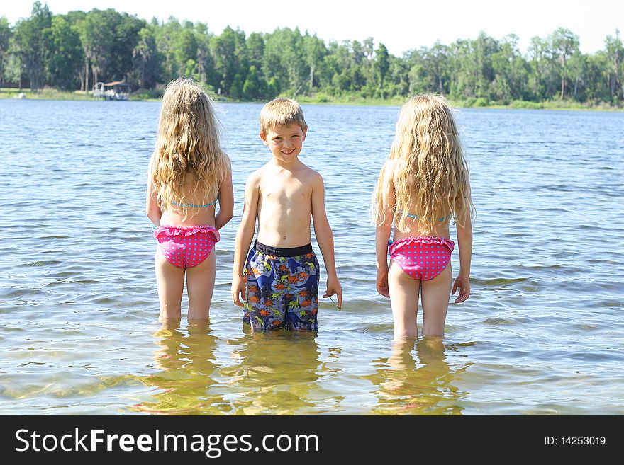 Little Boy With Friends In The Water