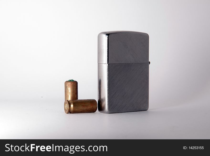 Metal Lighter and bullets on white background