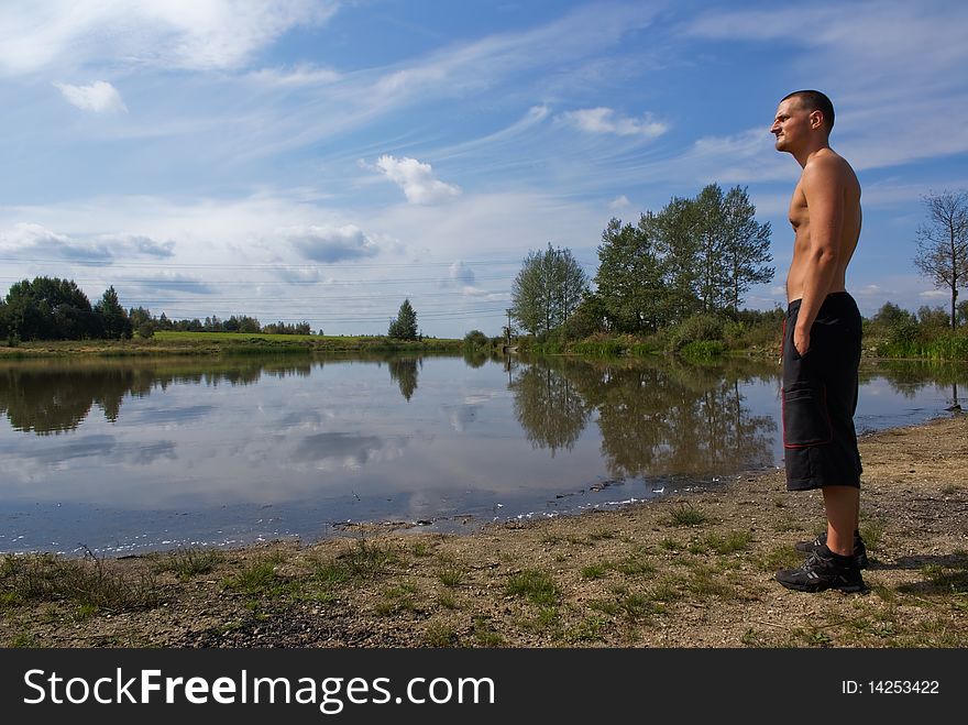 Young Man Looking At The Water Surface