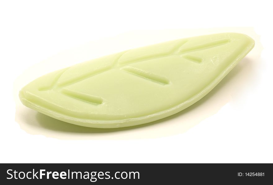 A designer bar of soap shaped like a green leaf. A designer bar of soap shaped like a green leaf.