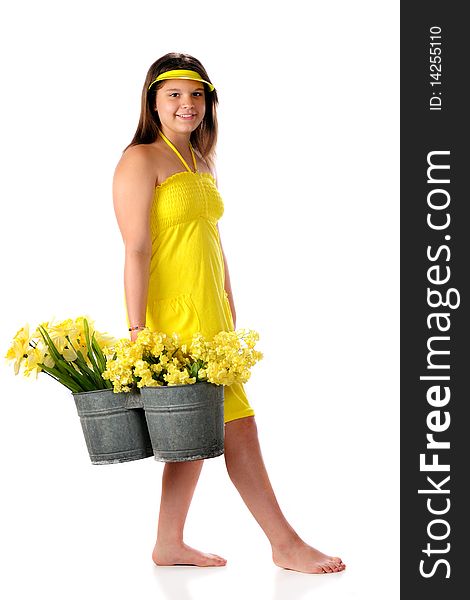 An attractive young teen in a bright yellow sundress carrying a double-bucket full of yellow spring flowers. Isolated on white. An attractive young teen in a bright yellow sundress carrying a double-bucket full of yellow spring flowers. Isolated on white.