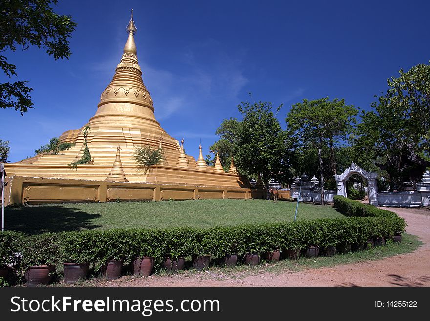 Mimetic Gold Pagoda with blue sky and green tree