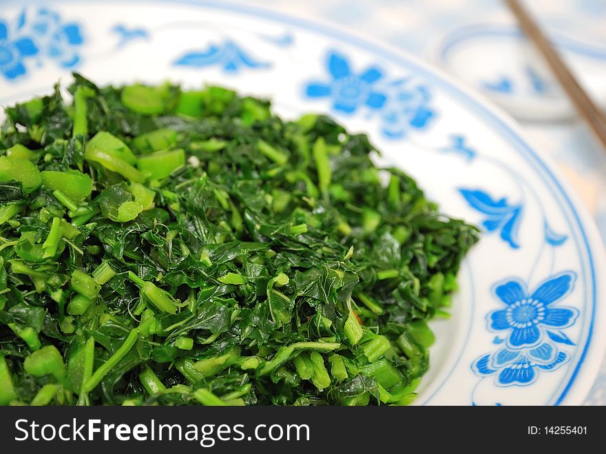 Simple green leafy vegetables from the Brassica Rapa family cooked Chinese style. For concepts such as food and beverage, diet and nutrition, and healthy eating.