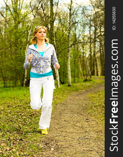 Pretty young woman running in park. Pretty young woman running in park