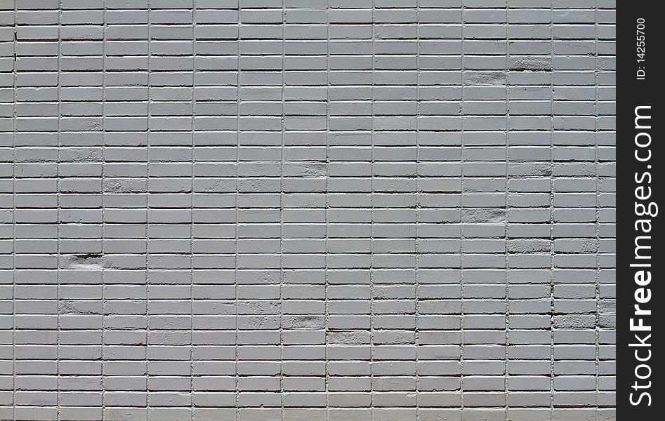Close-up of a brick wall that has been painted gray from distance. Close-up of a brick wall that has been painted gray from distance