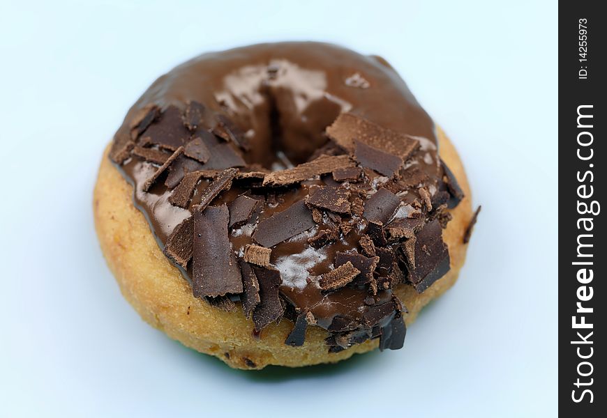 Chocolate donuts in a tray isolated against a blue background