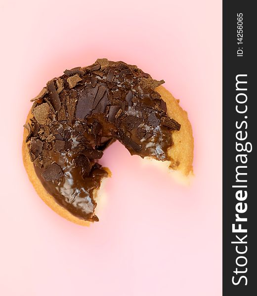 Chocolate donuts in a plate isolated against a pink background